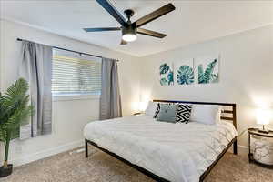 Carpeted bedroom with baseboards and ceiling fan
