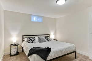Bedroom with carpet flooring and a textured ceiling