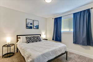 Carpeted bedroom with baseboards