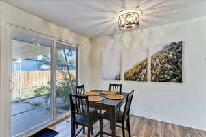 Dining room featuring wood finished floors and a chandelier