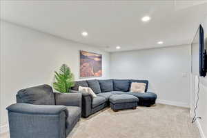 Living room featuring light carpet and recessed lighting