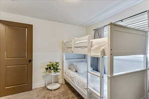 Bedroom featuring carpet flooring and a textured ceiling