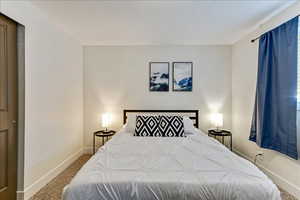 Bedroom with light carpet and baseboards