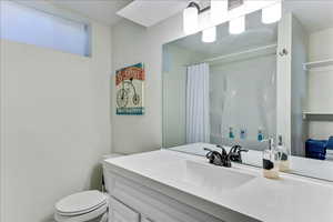 Full bathroom with vanity and curtained shower