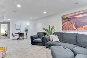Living room featuring light colored carpet and recessed lighting