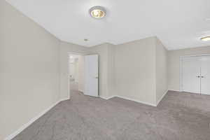 Unfurnished bedroom with carpet flooring and a closet