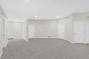 Below grade area featuring light carpet and recessed lighting
