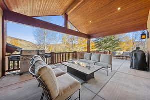 View of patio / terrace featuring an outdoor living space with a fire pit, a mountain view, and a grill