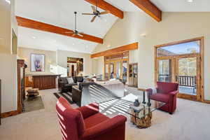 Living room with high vaulted ceiling, french doors, light colored carpet, recessed lighting, and beamed ceiling