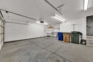 Interior of the garage showing the auto door opener and stairway to the 2nd floor storage