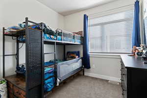 Carpeted bedroom featuring with a window and can lighting