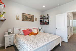 Primary bedroom featuring can lighting