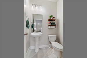 Half bathroom featuring tile patterned floors and toilet