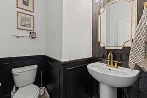 Bathroom with toilet and wainscoting