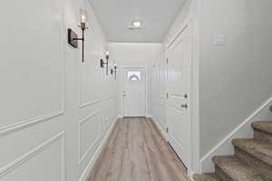 Doorway featuring wood finished floors and stairway