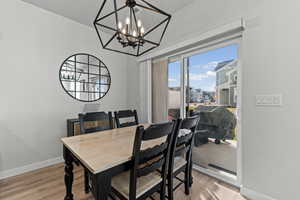 Dining space featuring light wood finished floors and a chandelier