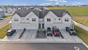 View of front facade featuring board and batten siding, a shingled roof, and a garage