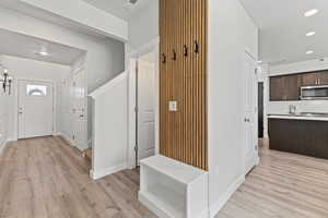 Entryway with recessed lighting and light wood-type flooring
