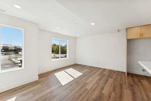 Unfurnished room featuring light wood finished floors, recessed lighting, and a textured ceiling