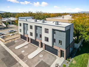 View of front of house featuring brick siding, a garage, and driveway