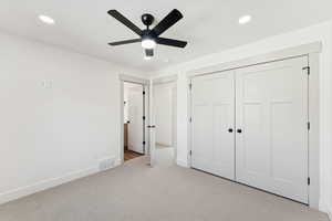 Unfurnished bedroom with carpet floors, recessed lighting, a closet, and ceiling fan