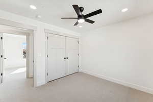 Unfurnished bedroom featuring light colored carpet, recessed lighting, a closet, and ceiling fan