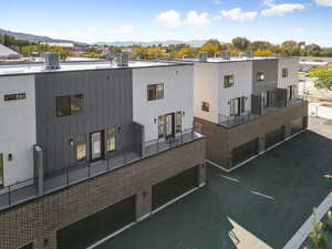 View of building exterior with a garage, a residential view, and a mountain view