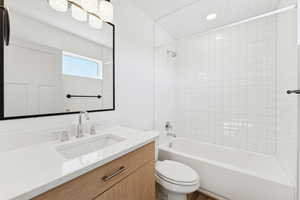 Full bath featuring washtub / shower combination and vanity