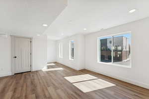 Unfurnished room with plenty of natural light, recessed lighting, and light wood finished floors
