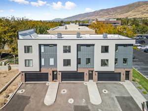 View of front of house featuring brick siding, driveway, and a garage