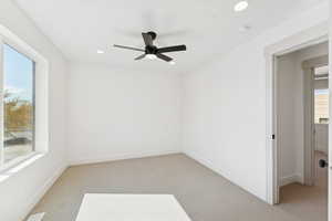 Spare room with light carpet, ceiling fan, and recessed lighting