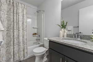 Bathroom with shower / tub combo with curtain and vanity