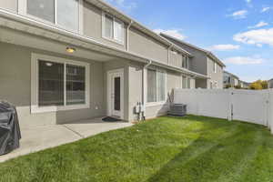 Back of house with stucco siding and a patio