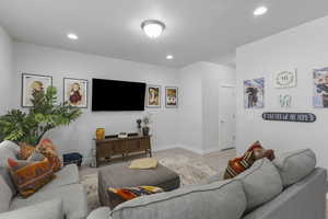 Living room featuring light wood-type flooring and recessed lighting