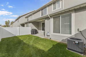 Back of house with stucco siding and a patio area