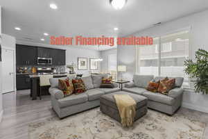 Living area with hanging lights and light wood finished floors