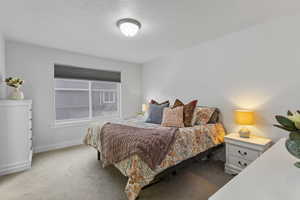 Bedroom with carpet floors and a textured ceiling