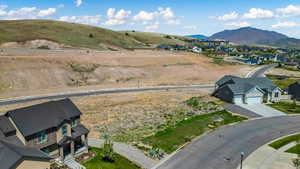 Aerial perspective of suburban area featuring a mountain backdrop
