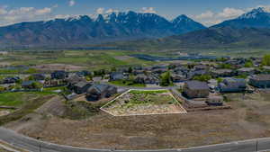 Aerial perspective of suburban area with property boundaries highlighted and a mountain backdrop