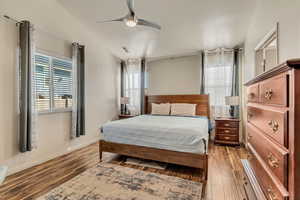 Spacious master bedroom with vaulted ceilings, laminate floors and abundant natural light