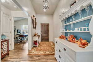 Entrance foyer featuring light laminate flooring and view of the 3rd bedroom