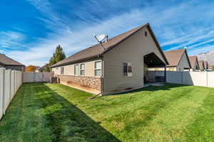 Rear view of property featuring a patio, a fenced backyard, a mountain view, a gate, and brick siding