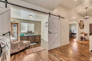 Bedroom 2 used as a home office with laminate floors and a barnyard door
