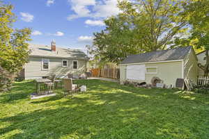 View of yard with a patio area and an outbuilding