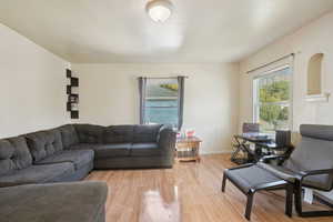 Living area with light wood finished floors and baseboards