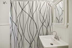 Bathroom featuring a shower with shower curtain