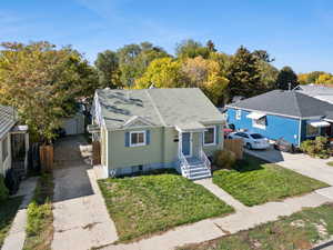 Bungalow-style house featuring a shingled roof and driveway