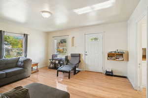 Living room with light wood finished floors and baseboards