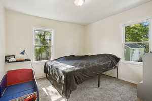 Carpeted bedroom featuring baseboards