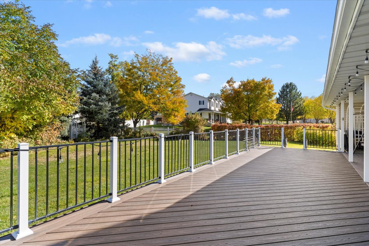 Deck with a yard and a residential view